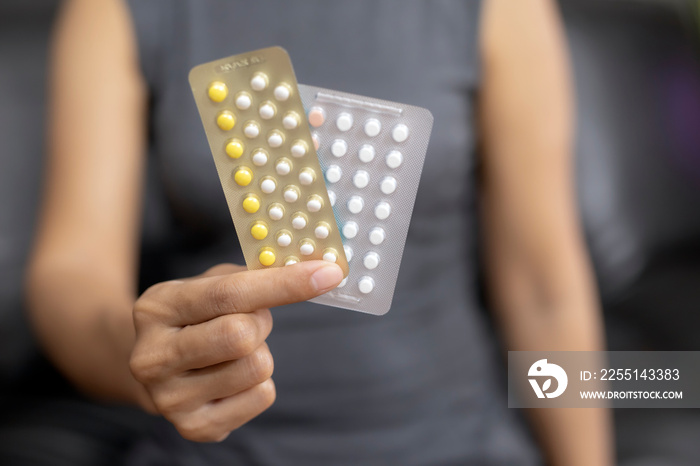 Woman holding combined oral contraceptive pill.Gynecology concept.