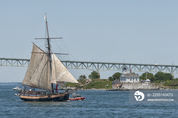 Tall ship in front of Rose Island Lighthouse in Newport, Rhode Island