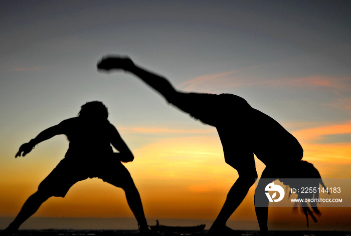 Sua America, Travel in Brazil North-est - Pipa Beach is one of the most famous beaches of Brazil - Two men plays Capoeira dancer in jericoacoara beach during the sunset