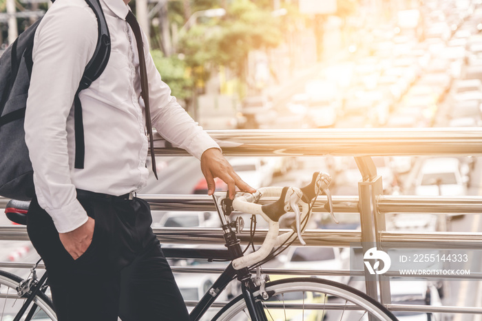 adult man on bike in the city in the morning with sun flare