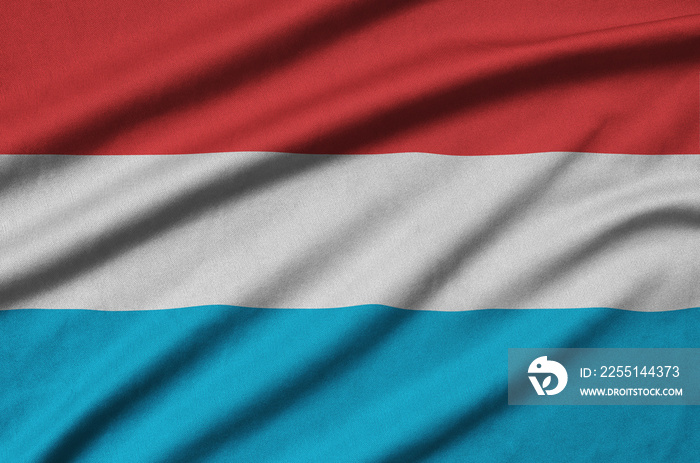 Luxembourg flag  is depicted on a sports cloth fabric with many folds. Sport team banner