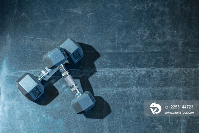 Selective focus on dumbbell, Healthy concept, 2 dumbbells on rough texture background with effect filer and copy space.