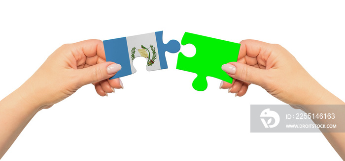 Woman hands are holding part of puzzle game. National mock up on white background. Guatemala