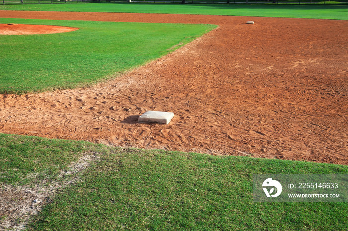 Youth baseball infield from first base side on sunny day