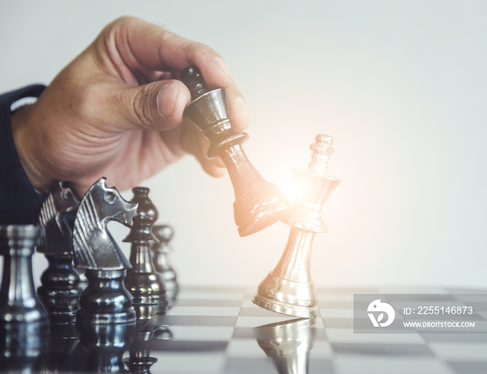 Detail of a hand making the first move in a chess game, moving the pawn one field forward. Selective focus