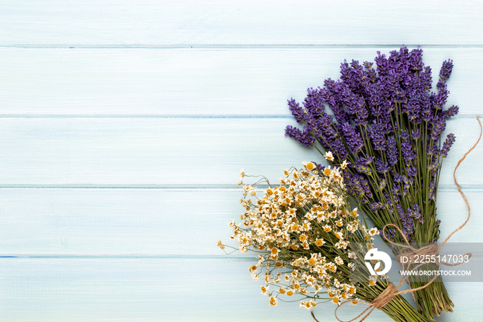 Grooming products and fresh lavender bouquet on white wooden table background.