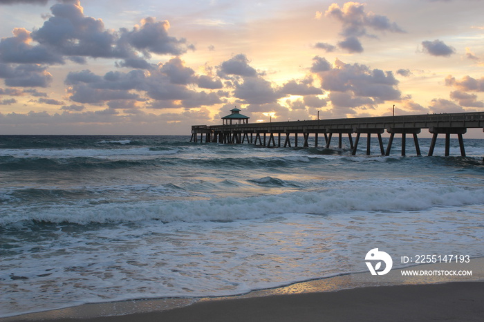 Sunrise by the pier at Deerfield Beach, Florida.