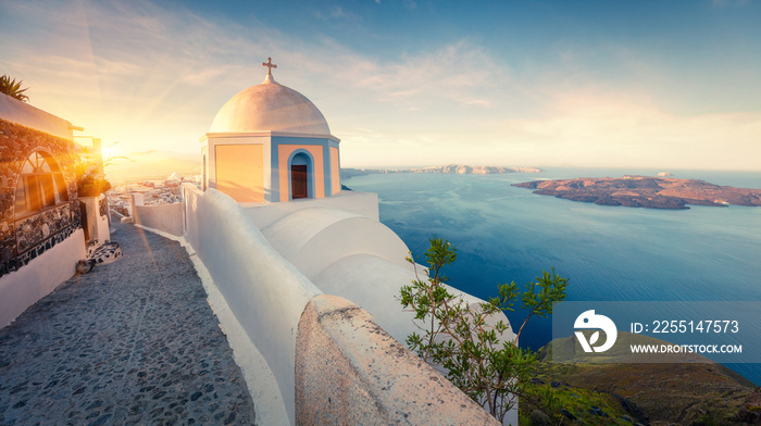 Sunny morning panorama of Santorini island. Picturesque spring sunrise on the famous Greek resort Thira, Greece, Europe. Traveling concept background. Artistic style post processed photo.