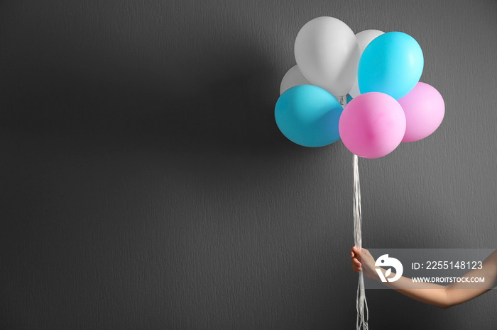 Colourful toy air balloons on grey background