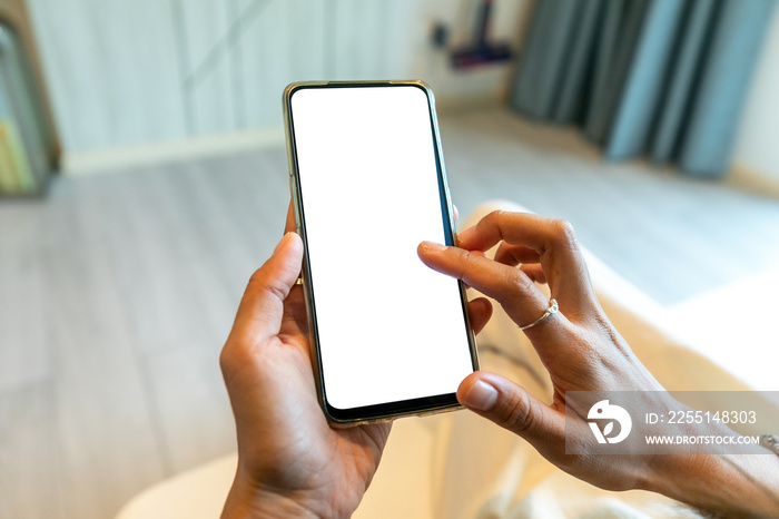 Female hand holding smartphone with blank screen and stylish frameless design, isolated on white background.