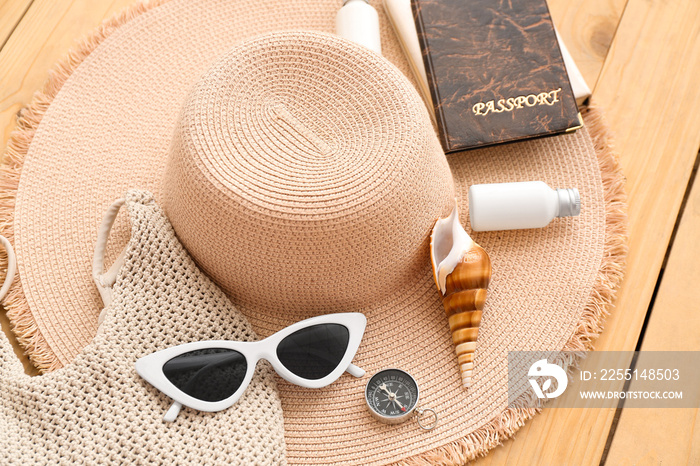 Female accessories for travelling with seashell on wooden background