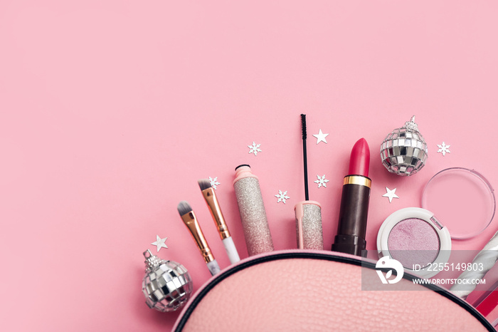 Composition with bag, cosmetics and Christmas decorations on pink background