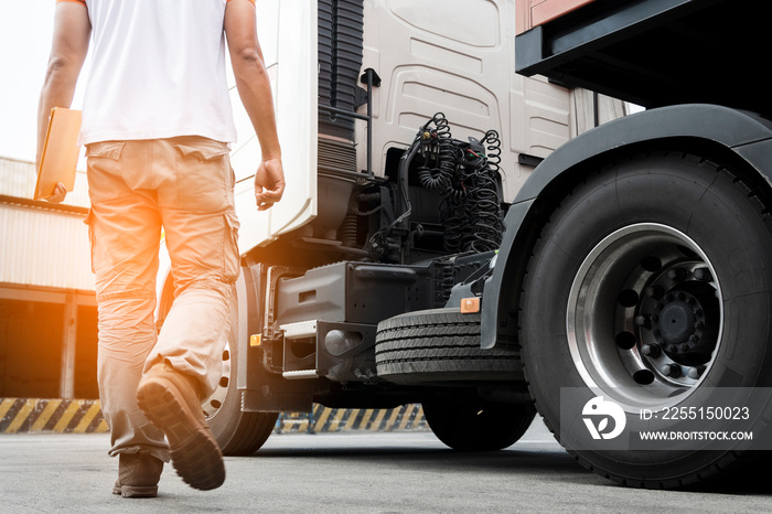 truck transportation, a truck driver walking around semi truck inspecting and safety check before driving a truck