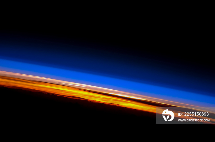 Sunset on the Earth’s horizon. Spectacular sunset view from Planet Earth. World’s horizon with colorful cloud layers. Indian Ocean. Elements of this image furnished by NASA.