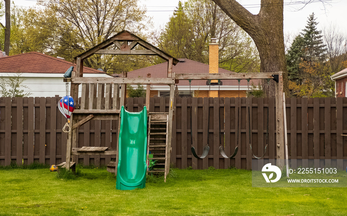 Swing set in backyard during spring season