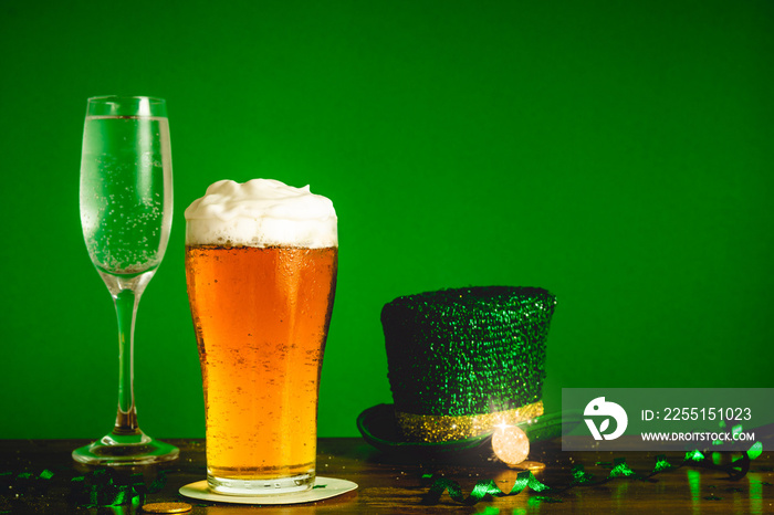 St Patricks day party celebration concept with glass of beer, champayne, leprechaun’s hat and gold coins on table top