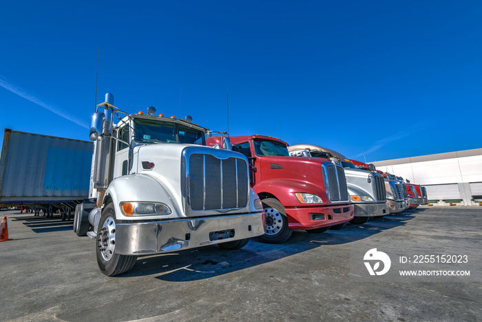 HDR image of Semi trucks lined up on a parking lot.