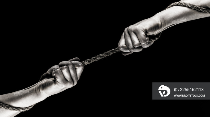 Hand holding a rope, climbing rope, strength and determination. Two hands, helping hand, arm, friendship. Rescue, help, helping gesture or hands. Conflict, tug of war. Rope, cord. Black and white.