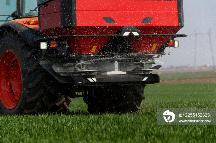 Tractor spreading artificial fertilizers