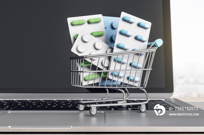 Online pharmacy medicine concept with pills in shopping cart on laptop keyboard