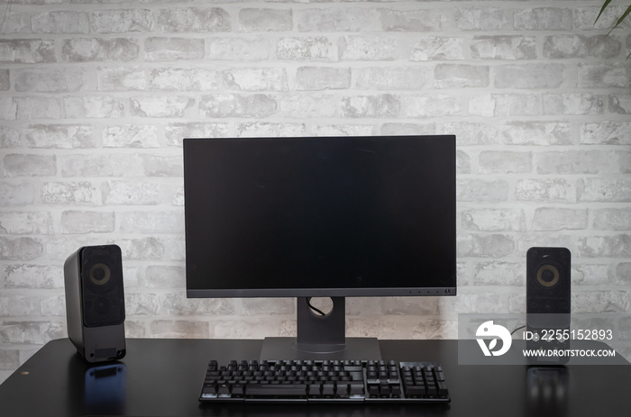 Computer workspace with black screen monitor and copy space for text or designs. Gamer Rig.