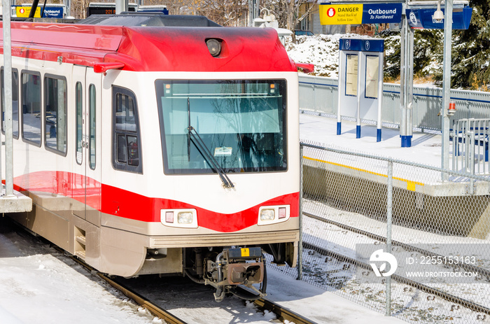 Light Rail Train Leaving a Station on Sunny Winter Day.