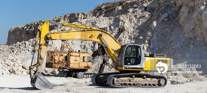 Yellow excavator - digging machine for digging and dumping the soil. Work in the quarry.