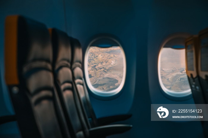 Airplane interior with window view over clouds. Concept of travelling.