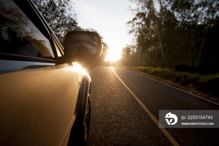 Car running on the road trip to goal and travel on brightest morning with sunrise.