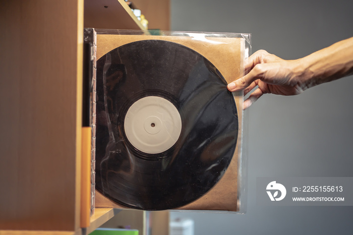 Picking a vinyl record from a shelf