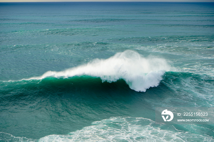 Big wave is breaking in the Atlantic ocean at Praia do Norte in Nazare, Portugal