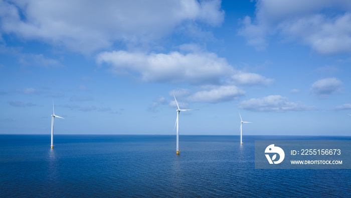 offshore windmill park with clouds and a blue sky, windmill park in the ocean aerial view with wind turbine Flevoland Netherlands Ijsselmeer. Green energy