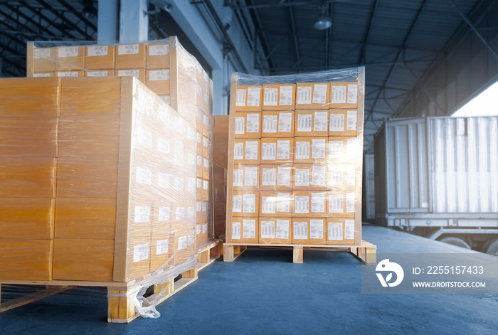 Stacked of Package Boxes Load into Cargo Container. Truck Parked Loading at Dock Warehouse. Delivery Service. Shipping Warehouse Logistics. Cargo Shipment. Freight Truck Transportation.