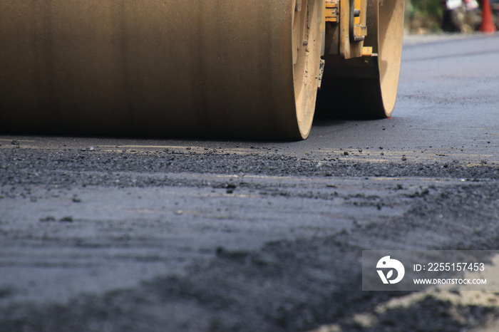 Road construction asphalt road by worker and roller machine. Asphalt road background