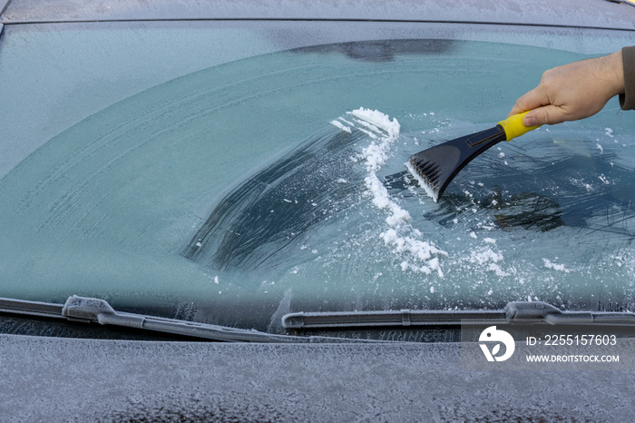 Hand scratching ice from car window