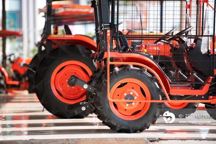 Selling colorful agricultural tractors in the showroom