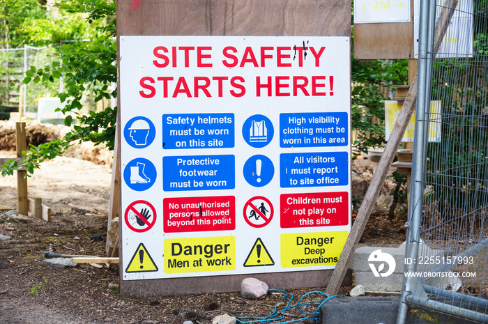 Construction site health and safety message rules sign board signage on fence boundary