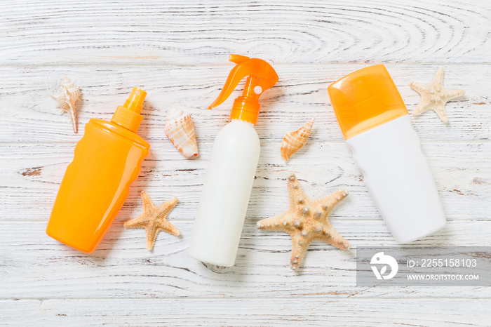 flat lay concept summer travel vacation. Sunscreen bottles with starfish on white wooden table with copy space