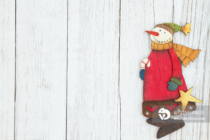 A snowman on weathered whitewash textured wood background