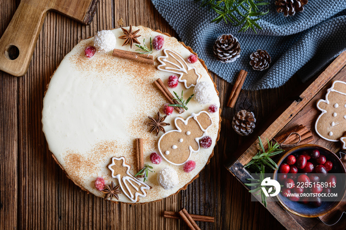 Eggnog gingerbread tart decorated with sugared cranberries, gingerbreads, cinnamon and star anise