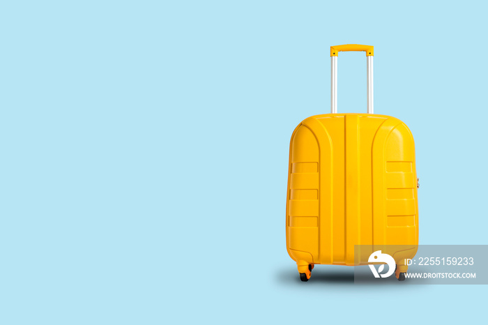 Yellow suitcase on a blue background. Travel and vacation concept in triples. Flat lay, top view