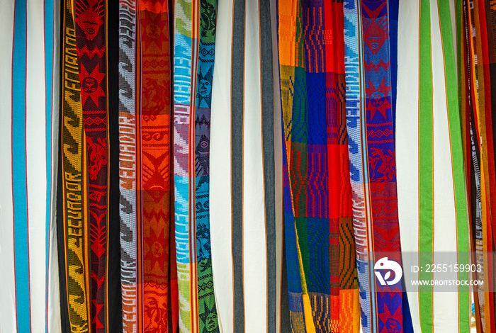 Colorful traditional textiles and rugs on the local art and craft market of Otavalo near Quito, South America.