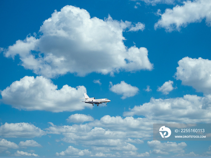 Private Falcon jet in blue skies over metal roof