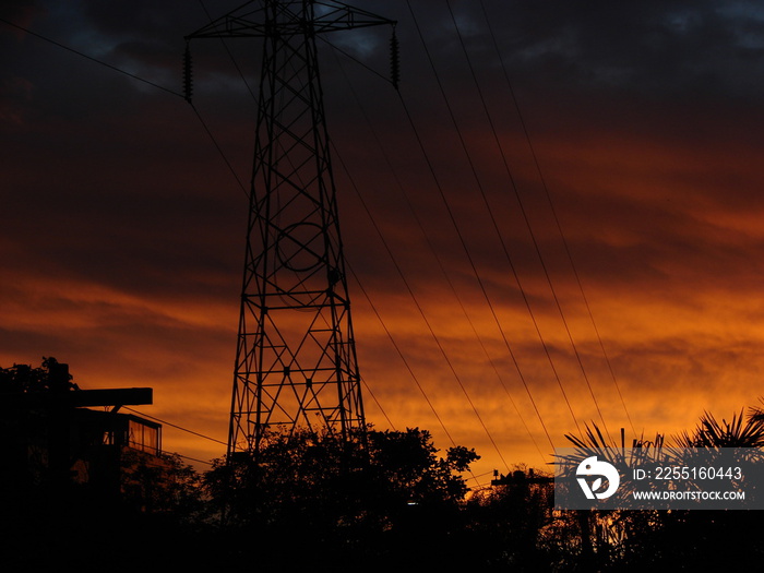 Sunset sky behind powergrid tower