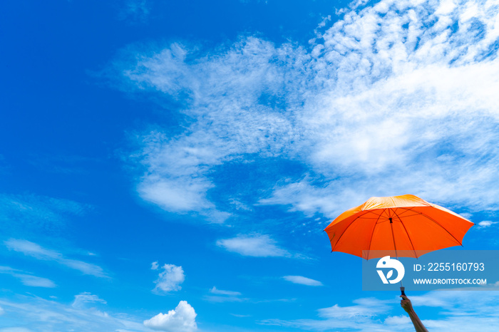 Multicolored of rainbow umbrella in bottom view for protect skin from the sun, high uv on the blue summer sky with white fluffy clound. Freedom in the blue sky.