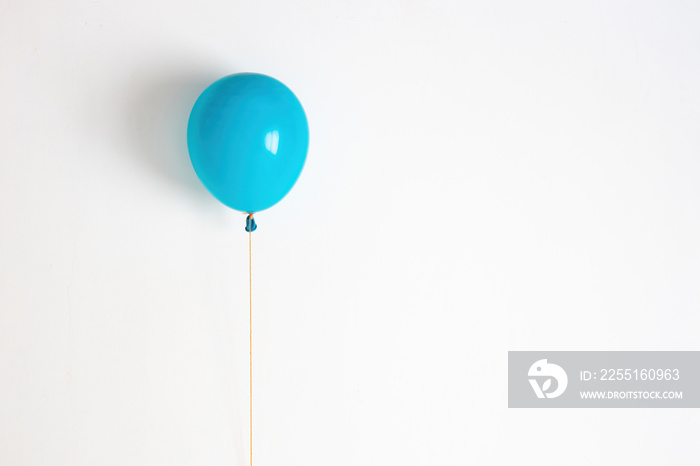 Blue balloon. A blue festive, joyful balloon on a string.