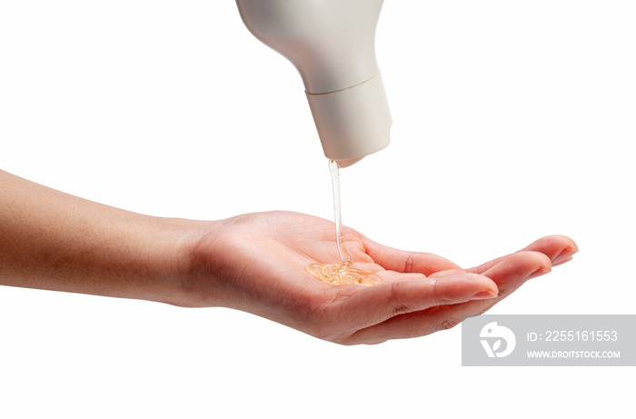 Liquid soap poured over woman’s hands on white background.