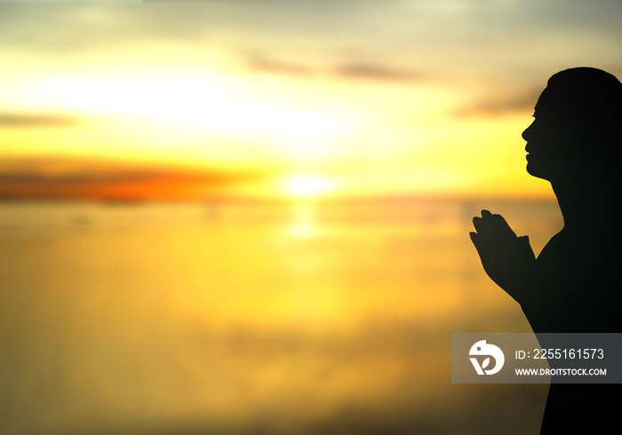 International women day concept: Silhouette woman pray at beach autumn sunrise background