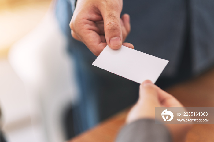 Two businessman holding and exchanging empty business card