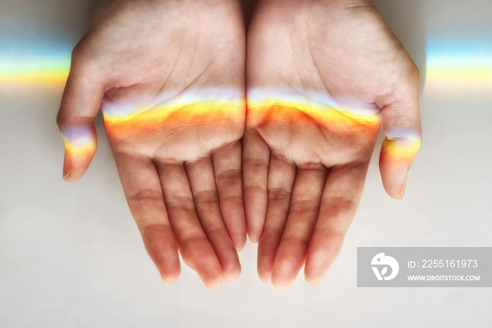 rainbow in the woman’s hands